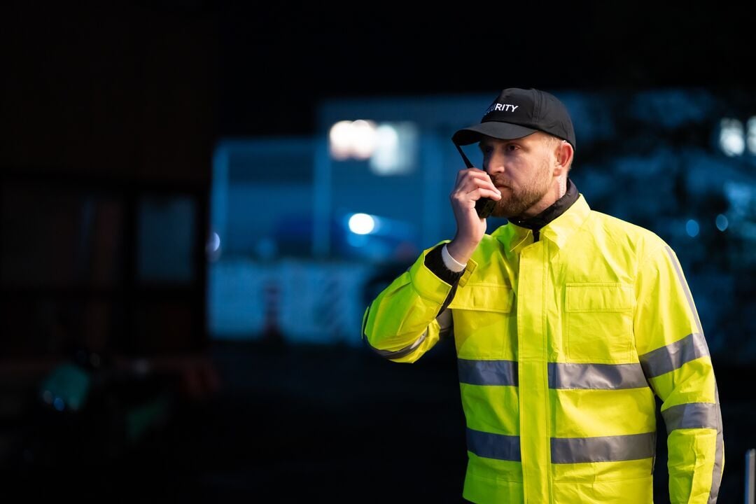 Vartija ulkona puhumassa radiopuhelimeen